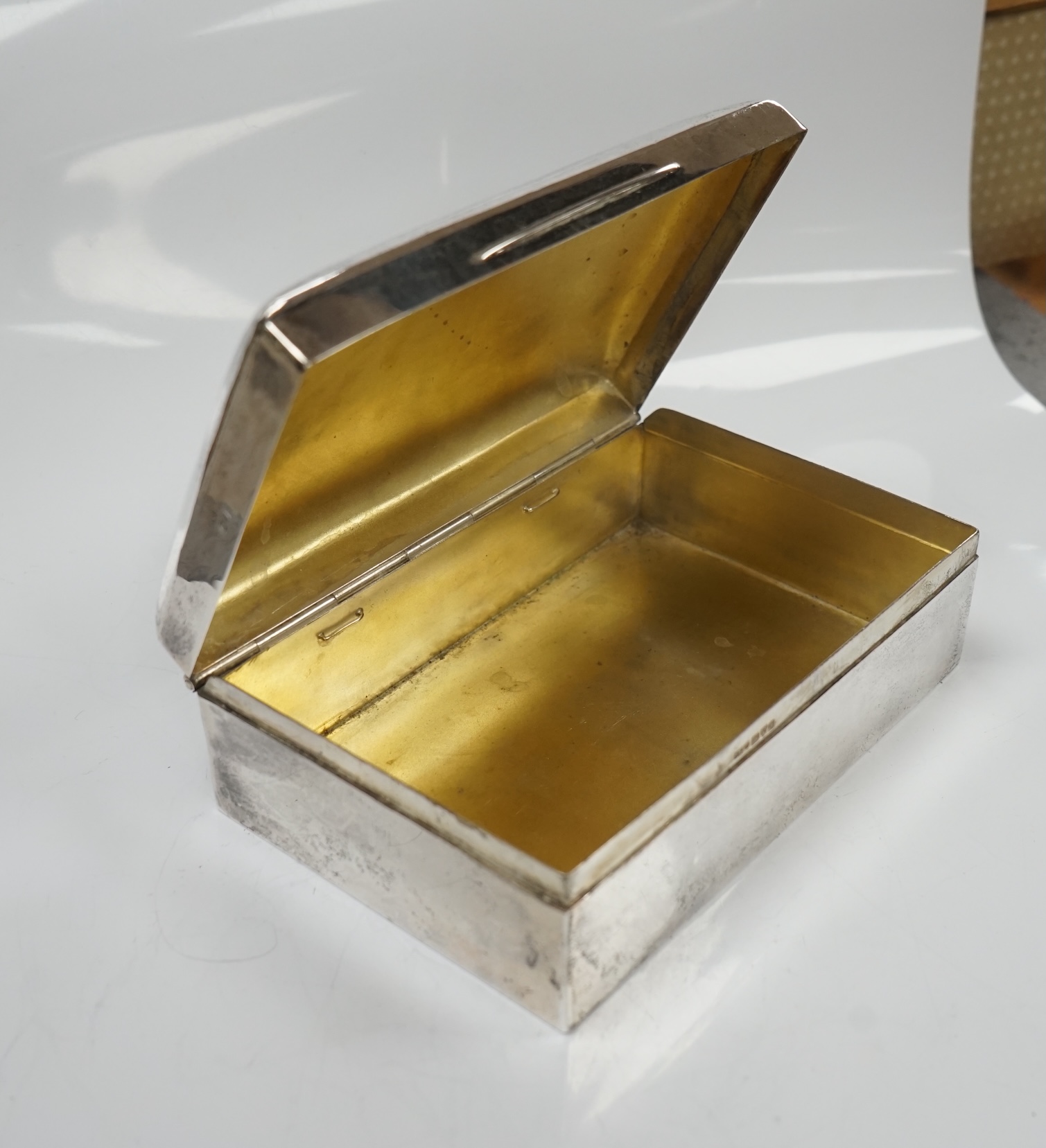 Two silver cigarette boxes, the largest by Stokes & Ireland, Chester, 1906, 14.7cm. Condition - poor to fair